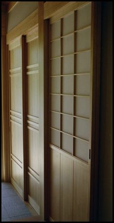 an empty room with wooden doors and shelves