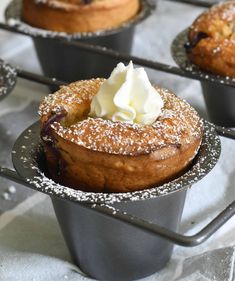 some cupcakes with icing and powdered sugar on them