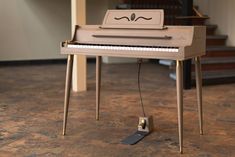 a small piano sitting on top of a wooden floor