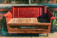 an old wooden bench with the word ford painted on it's back and bottom