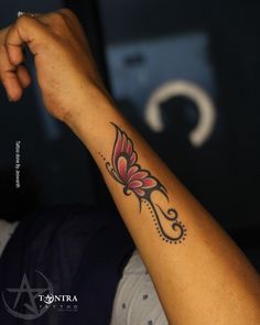 a woman's arm with a tattoo design on the left side of her arm