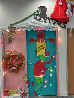 the grinch door is decorated with christmas lights and presents on it's side