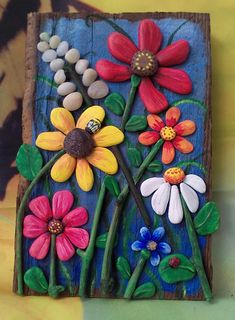 a painted wooden block with flowers on it