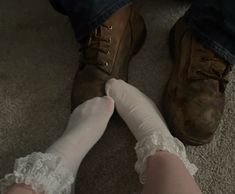 two people wearing white socks and lace garters on their feet, one is holding the other's leg