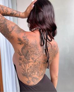 a woman with lots of tattoos on her back