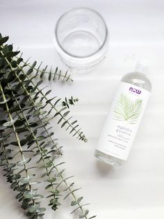 a bottle of water and some plants on a table