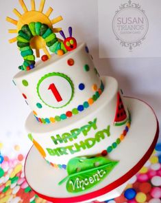 a birthday cake with the number one on it is decorated like a caterpillar