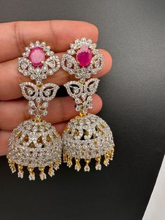 CZ Jhumki Color Stone EaringsColor : Diamond Finish JhumkasSize : Approx 2.5 Inches; Weight : Approx 18 Grams EachStones : CZ --Color-- Stone Antique Necklace Victorian, Jhumka Designs, Saree Jewellery, Dresses Traditional, Real Pearl Necklace, Jhumki Earrings, Traditional Earrings, Crystal Beads Bracelet, Kundan Necklaces