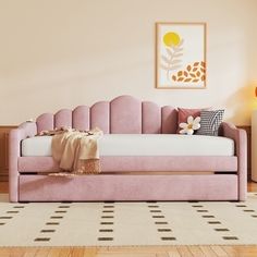 a living room with a pink couch and white rug