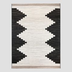 a black and white rug hanging on the wall