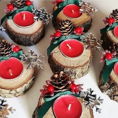 twelve red candles with pine cones and evergreen leaves on them are arranged in a circle