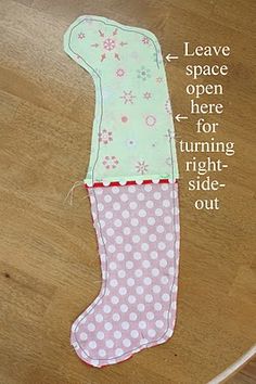 an oven mitt made out of pink and white polka dots on a wooden floor