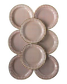 four brown and white checkered plates stacked on top of each other in the shape of five circles