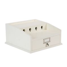 a white box with four compartments on the bottom and one drawer open to show two keys