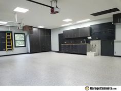 an empty garage with lots of cabinets and ladders