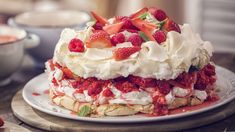 a cake with strawberries and whipped cream on top