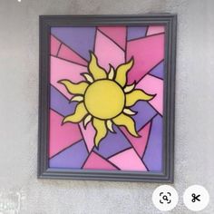 the sun is depicted in this colorful stained glass piece on the side of a building