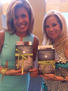 two women holding up some books in their hands