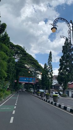 an empty street is shown in front of some trees and buildings on the other side