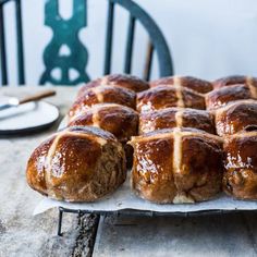 freshly baked hot cross buns on a baking sheet