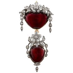 A Victorian garnet and diamond pendant/brooch, the heart shaped cabochon garnet surmounted by a floral and foliate spray, set throughout with rose-cut, old brilliant-cut and cushion cut-diamonds, to a delicately etched gold closed back setting with compartment for hair, all suspending a similarly set pear shaped cabochon garnet drop, circa 1840, measuring approximately 5.7 x 2.8cm, gross weight 14.4 grams. This antique brooch is in very good condition for its age. Unmarked, tested as silver and Brooch Wedding, Pendant Brooch, Bow Brooch, Wedding Brooch, Bold Jewelry, Antique Brooches, Garnet Jewelry, Diamond Brooch, Heart Brooch