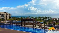 an outdoor swimming pool next to the ocean