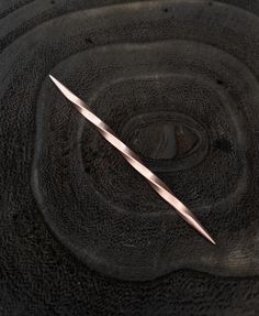 a pair of scissors sitting on top of a black surface