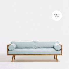 a blue couch sitting on top of a wooden frame