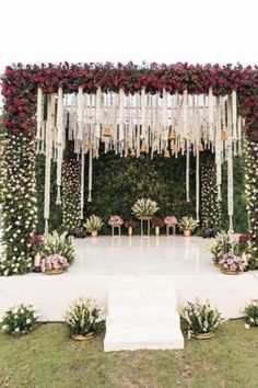 an outdoor ceremony setup with flowers and greenery