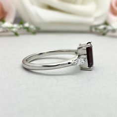 This beautiful ring is made from genuine 925 sterling silver with rhodium plating. Ring details- -The Main stone is an Emerald Cut 8mm by 6mm Lab Created Alexandrite Stone -Side stones are 4mm by 2mm Tapered Baguette simulated diamonds -Ring is casted in solid 925 sterling silver with rhodium plating (rose gold and yellow gold plated also available, please check the drop down menu for more options) -The Total face height of the ring measures 8mms and the band width measures 1.6mms -Each ring is Garnet Wedding Rings, Engagement Ring Three Stone, Wedding Rings Photos, Ring Three Stone, Alexandrite Stone, Silver Wedding Ring, Wedding Rings Round, Sterling Silver Wedding Rings, Simulated Diamond Rings