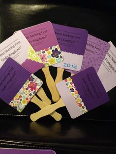 a bunch of cards that are on top of a black table in front of a chair