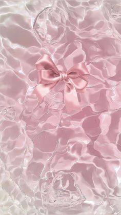 a pink bow sitting on top of water