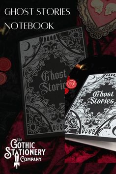 the ghost stories notebook is laying on a red velvet surface with other items surrounding it