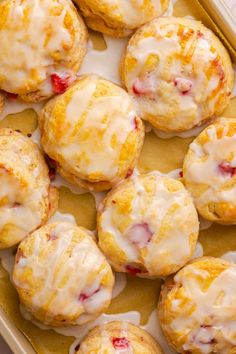 a tray filled with orange muffins covered in icing