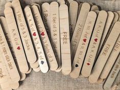 wooden bookmarks with writing on them are lined up in the shape of heart shapes