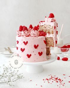 a cake with pink frosting and hearts on it