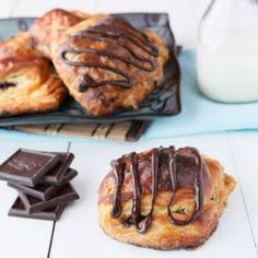 chocolate covered pastries and milk on a table