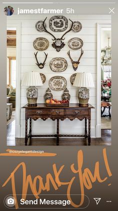 a table with plates and lamps on it in front of a wall that says thank you