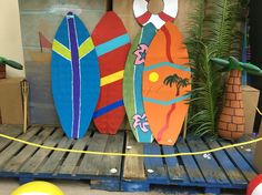 three surfboards are sitting on top of a pallet