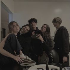 a group of people taking a selfie in a bathroom