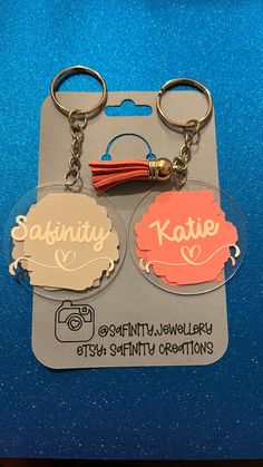 two keychains with the words sakinty and kotie on them