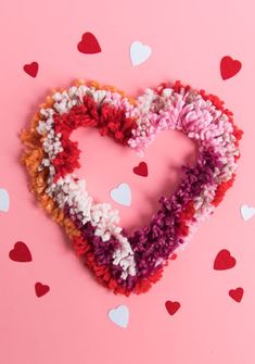 two crocheted hearts on a pink background with red, white and blue hearts