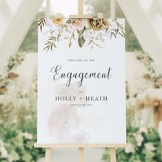 a sign with flowers on it that says, welcome to the engagement of holly and heath