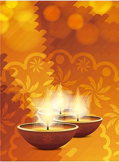 two lit candles sitting on top of a bowl in front of an orange background with floral designs