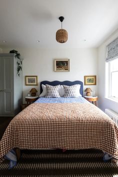 a bed sitting next to a window in a bedroom