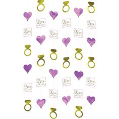 pink and gold wedding decorations with hearts, rings and i love you hanging from the ceiling