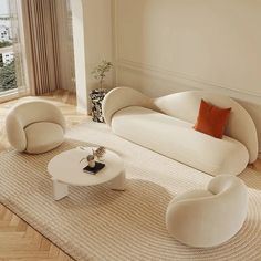 a living room filled with furniture and a large window