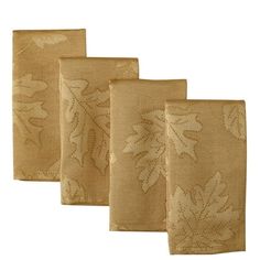 four placemats with embroidered leaves on them