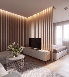 a living room filled with furniture and a flat screen tv on top of a wooden wall