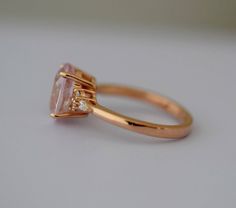 "Engagement ring. Rose gold engagement ring. Peach champagne sapphire ring by Eidelprecious. This is my new Campari design. Very beautiful ring features a natural non-treated sapphire in gorgeous Peach Champagne color. It changes constantly depending on the lightening. This stone is 3.15ct, eye clean, oval cut, unheated. Set into our new Campari design. Accented stones are natural diamonds, 2 round and 1 pear on each side. 6 diamonds in total, TDW approx 0.35ct. Details: Main Stones Origin: Natu Oval Rose Gold Solitaire Sapphire Ring, Oval Solitaire Sapphire Ring In Rose Gold, Rose Gold Oval Sapphire Solitaire Ring, Oval Rose Gold Sapphire Solitaire Ring, Rose Gold Sapphire Ring With Diamond, Oval Cut, Oval Rose Gold Sapphire Ring With Diamond, Rose Gold Oval Sapphire Ring, Oval Sapphire Ring In Rose Gold With Diamonds, Rose Gold Oval Sapphire Ring With Brilliant Cut